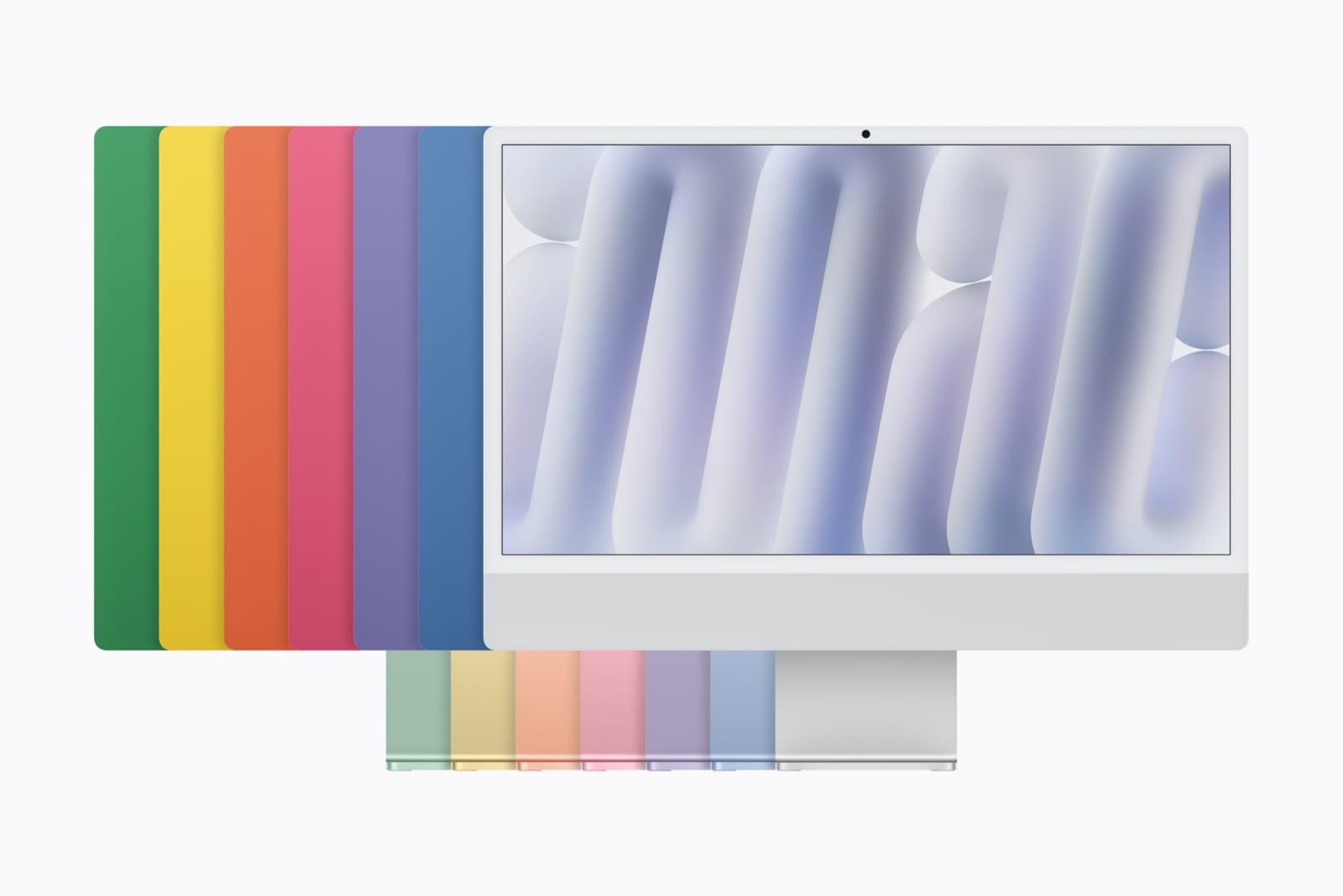 A silver iMac in front of the backs of 6 colored iMacs in green, yellow, orange, pink, purple and blue, with matching stands below